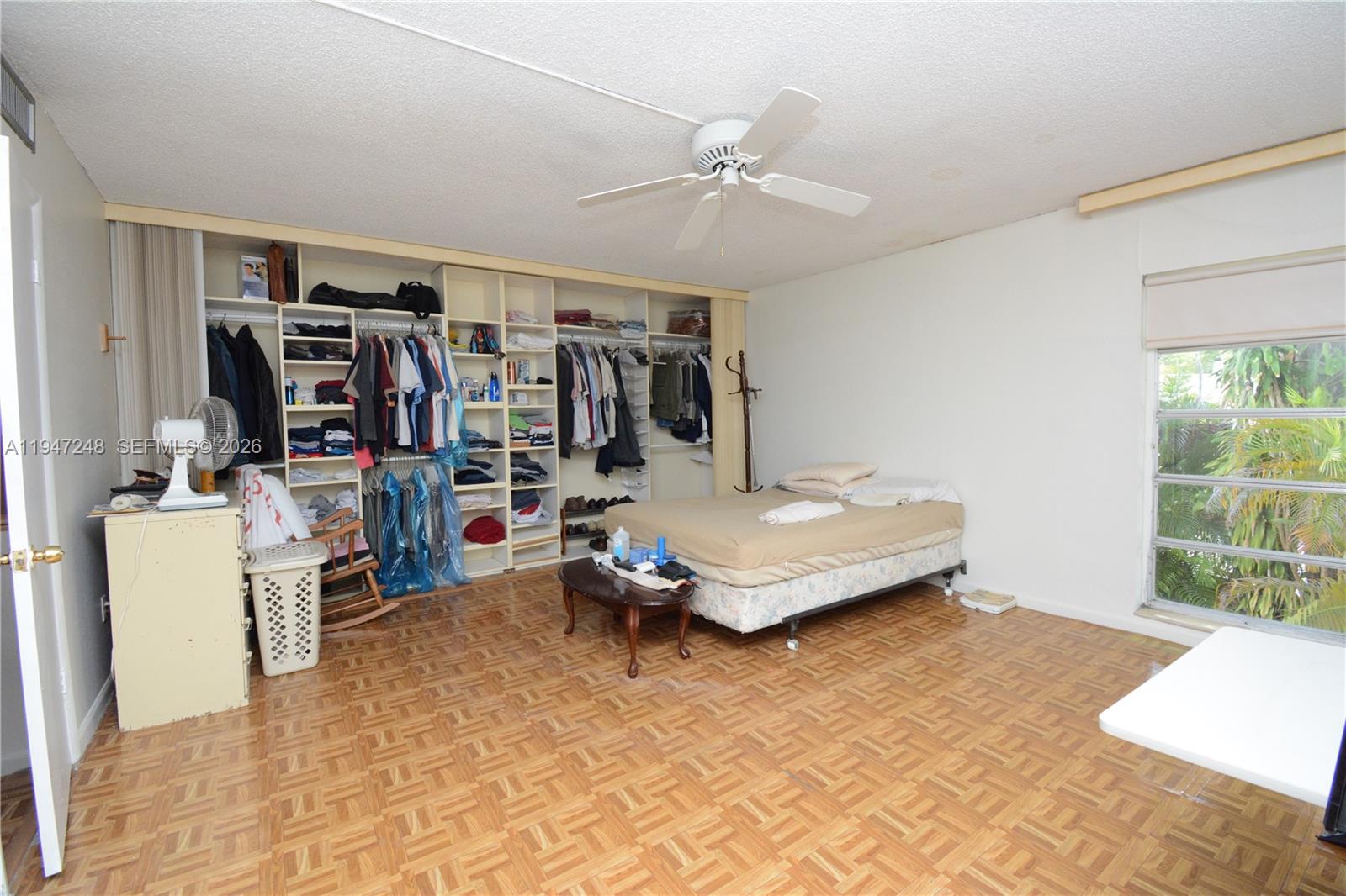 13935 Southwest 84th Street, Unit 905 Miami, FL 33183 - Photo 17 of 33 a bedroom with a bed and a large window