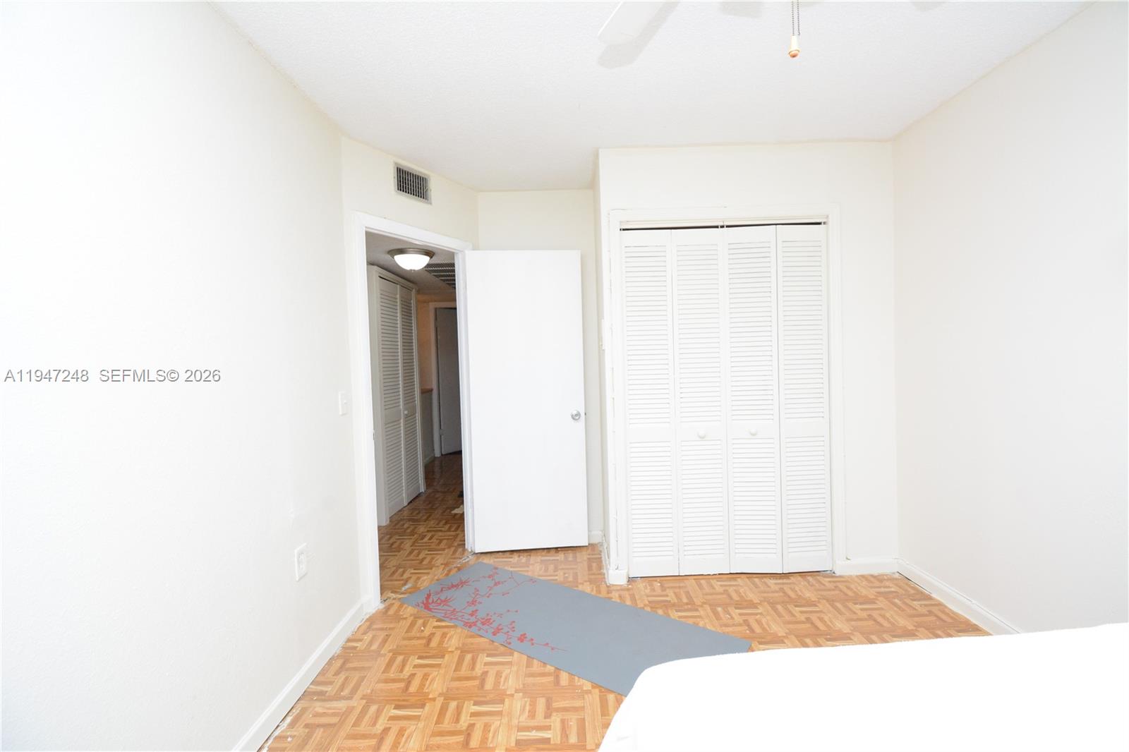 13935 Southwest 84th Street, Unit 905 Miami, FL 33183 - Photo 20 of 33 a bedroom with a bed and a mirror