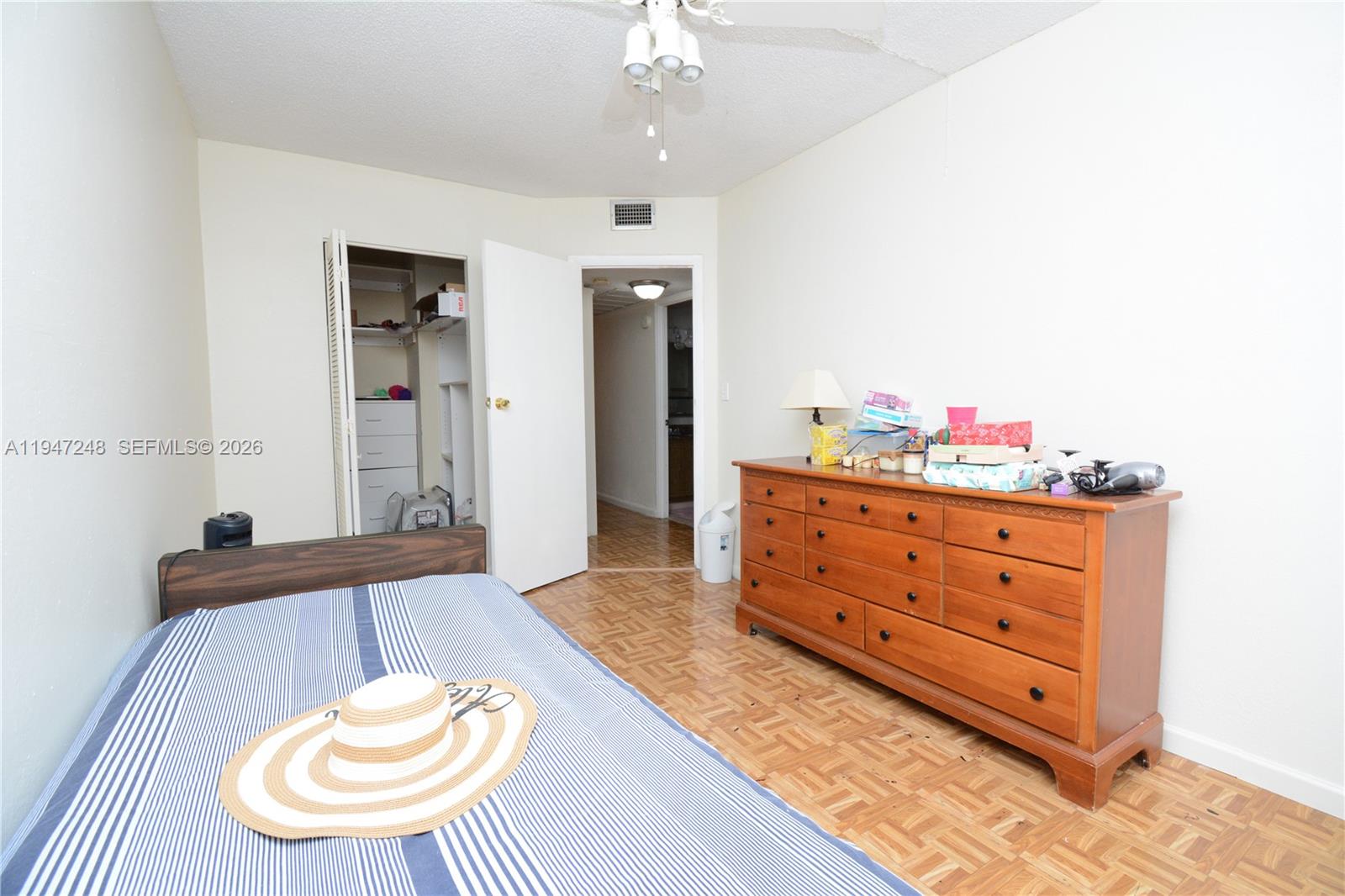 13935 Southwest 84th Street, Unit 905 Miami, FL 33183 - Photo 23 of 33 a room with a dresser and a chandelier