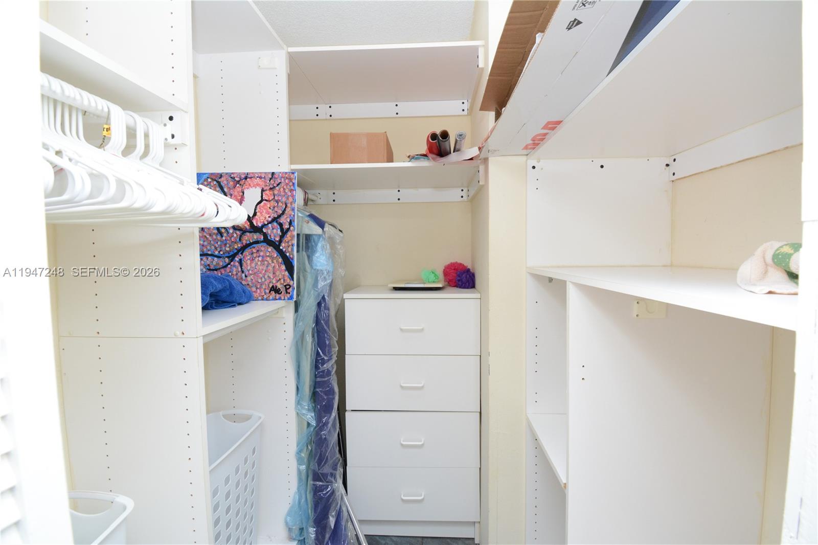 13935 Southwest 84th Street, Unit 905 Miami, FL 33183 - Photo 25 of 33 a view of walk in closet with clothes and shoes