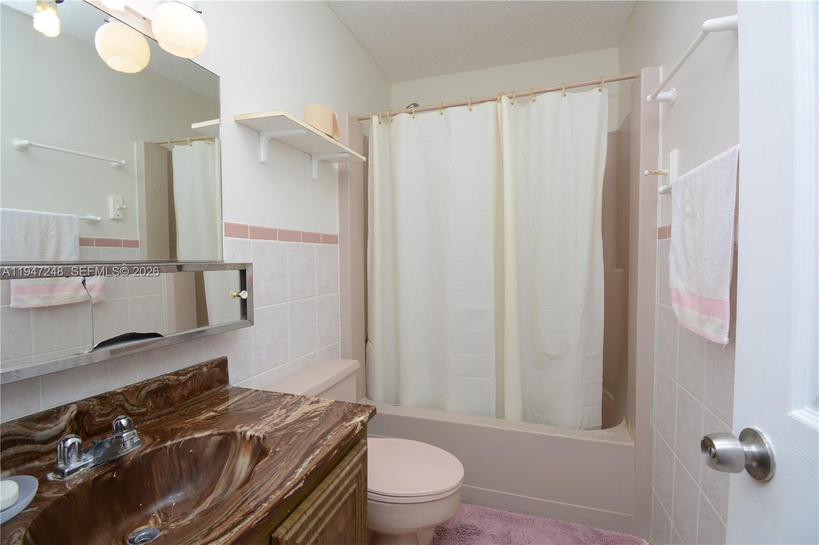 13935 Southwest 84th Street, Unit 905 Miami, FL 33183 - Photo 27 of 33 a bathroom with a granite countertop sink toilet and shower