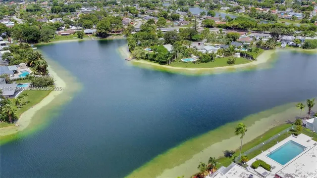 an aerial view of a house with a lake view