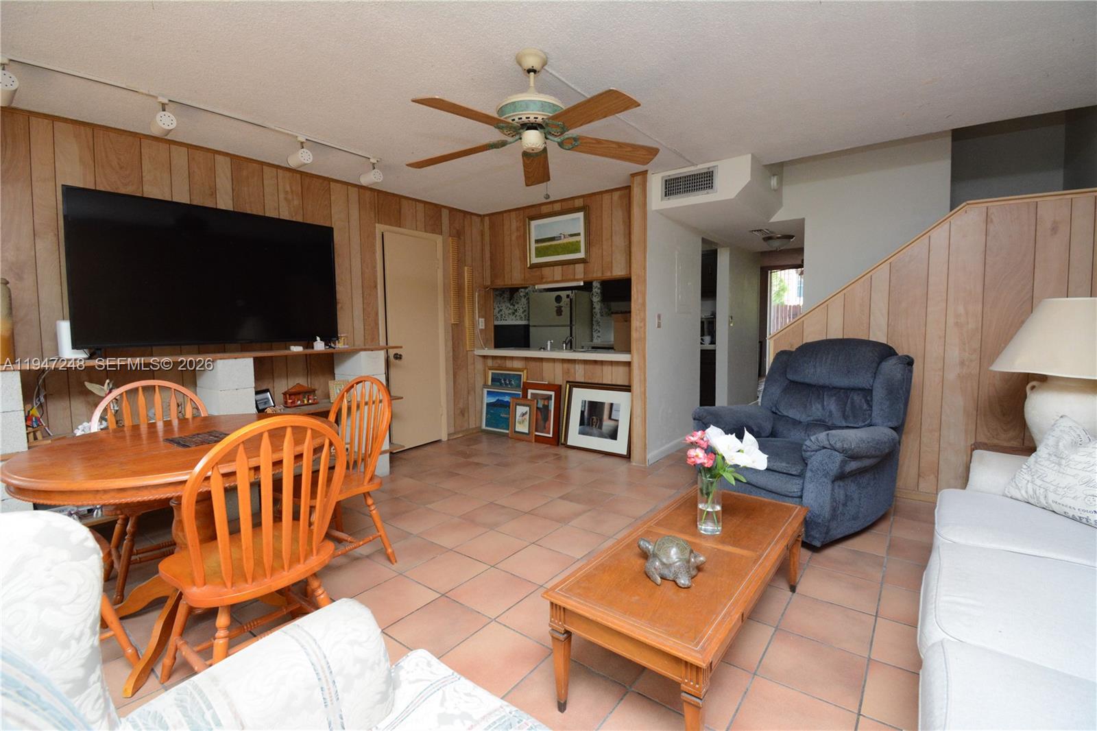 13935 Southwest 84th Street, Unit 905 Miami, FL 33183 - Photo 5 of 33 a living room with furniture and a flat screen tv