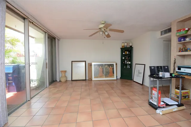 a view of a livingroom with workspace and a window