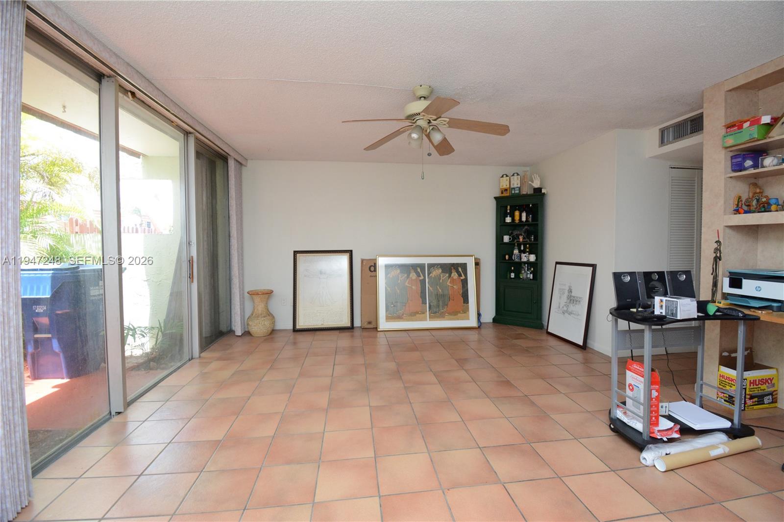 13935 Southwest 84th Street, Unit 905 Miami, FL 33183 - Photo 8 of 33 a view of a livingroom with workspace and a window