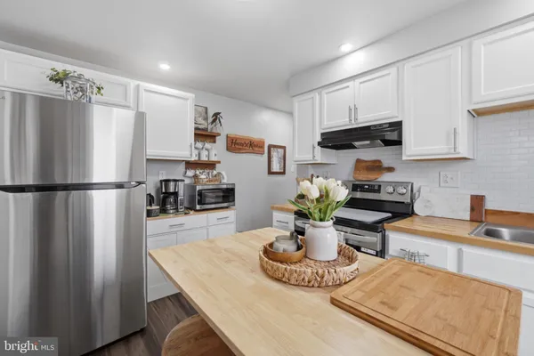 a kitchen with a stove a sink and a refrigerator