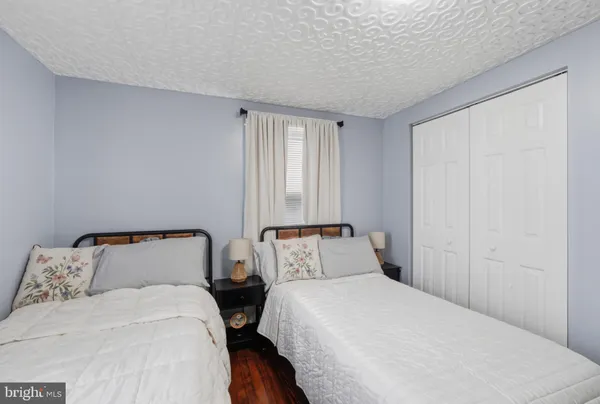 a bedroom with two beds and a window