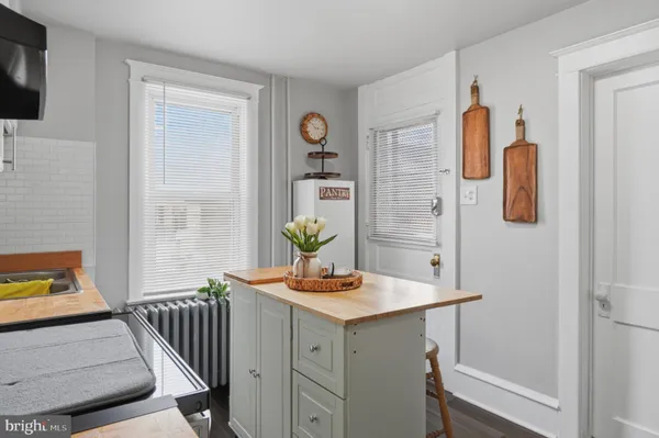 a kitchen with a stove a sink a refrigerator and cabinets