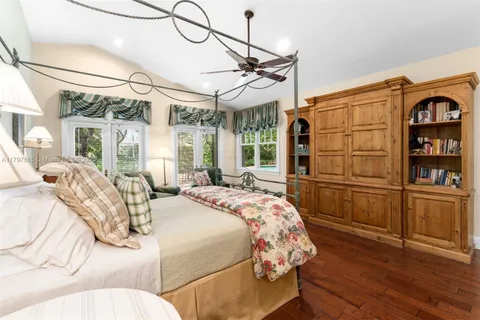 a spacious bedroom with a bed and a large window