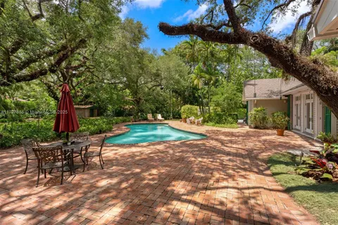 a view of house with yard and green space