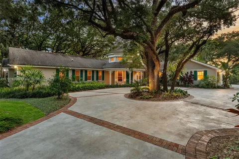 a view of a house with swimming pool and sitting area