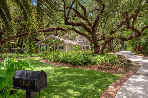 a living room with furniture fireplace and large windows