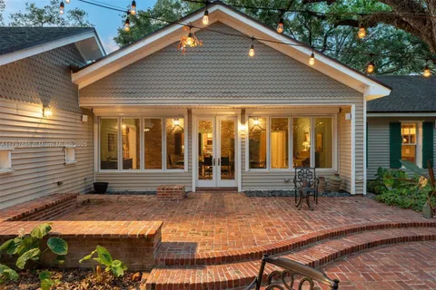 an aerial view of residential house with outdoor space and trees all around