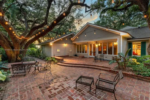 a view of a house with a tree in the yard