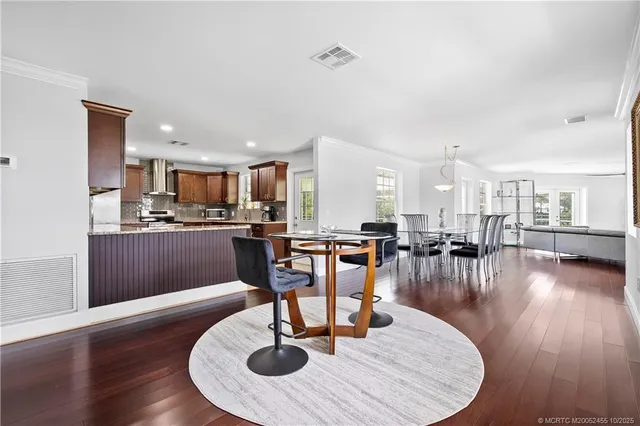 a living room with dining room and kitchen view