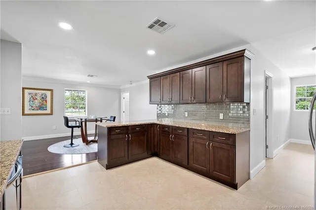 a kitchen with stainless steel appliances granite countertop a sink and cabinets