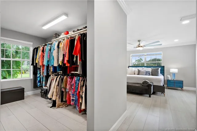 a view of walk in closet with clothes and shoes