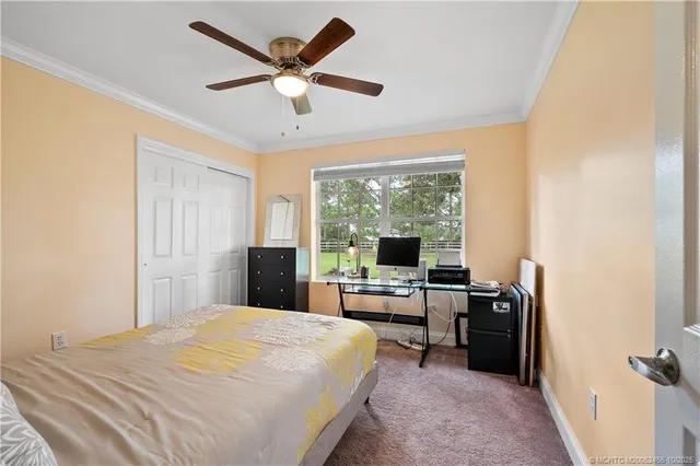 a bedroom with a large bed and a flat tv screen