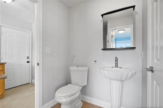 a view of walk in closet and bathroom