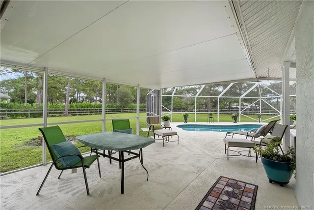 a view of a house with backyard porch and sitting area