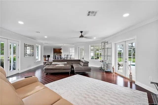 a living room with furniture and a wooden floor