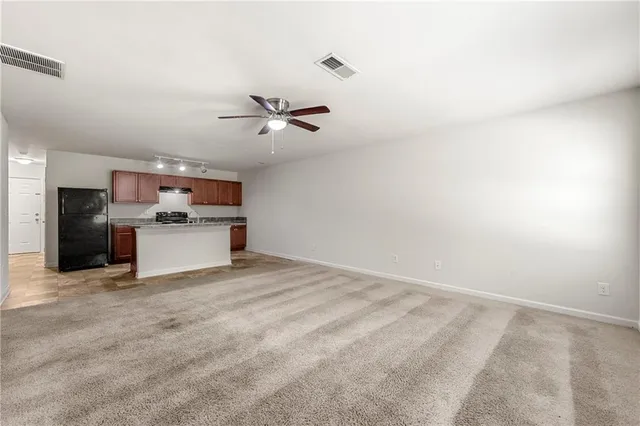 a view of a kitchen with a sink and a refrigerator