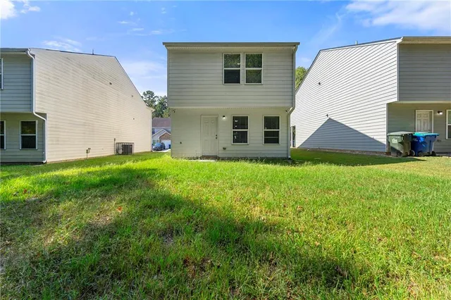 a view of house with backyard