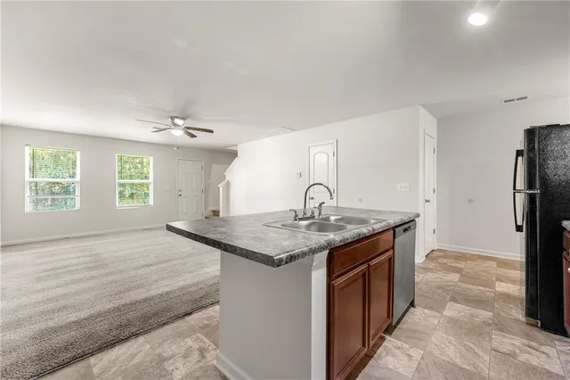 a kitchen with a sink and a refrigerator