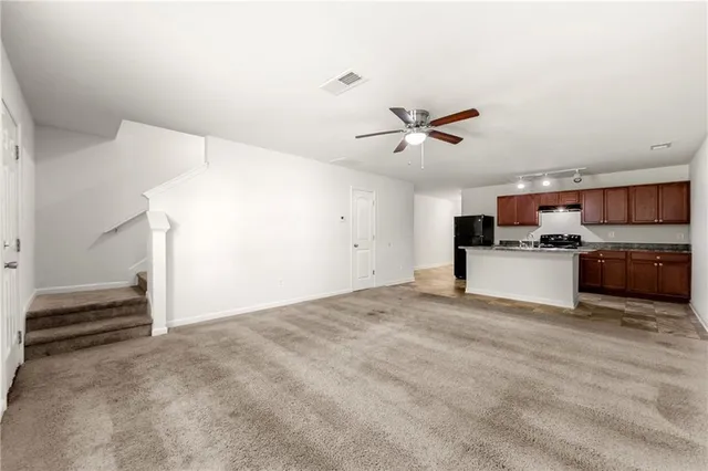 a view of kitchen with wooden floor and a ceiling fan