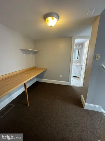 a view of room with hardwood floor and fan