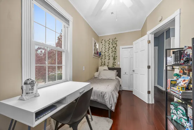 a view of a kitchen with fridge and wooden floor