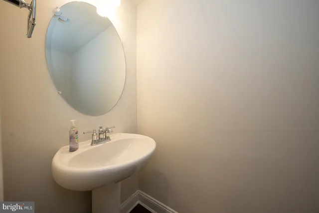 a bathroom with a sink a mirror and a toilet