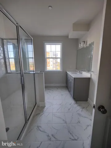 a room with window and a refrigerator