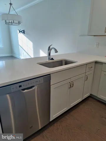 a kitchen with a sink a refrigerator and cabinets