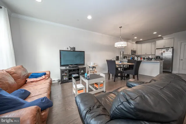 a living room with furniture and kitchen view