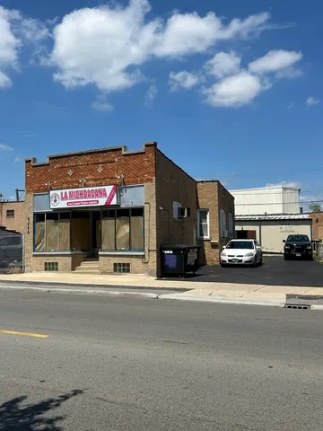 a view of a building with car parked