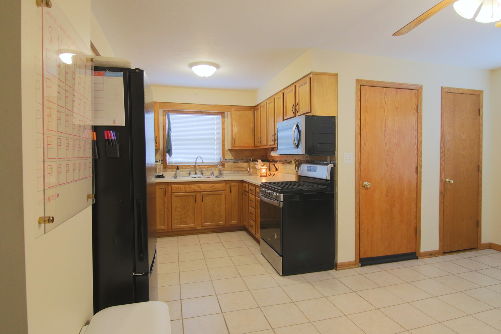 105 North Maple Street Grant Park, IL 60940 - Photo 6 of 14 a kitchen with a refrigerator and a sink