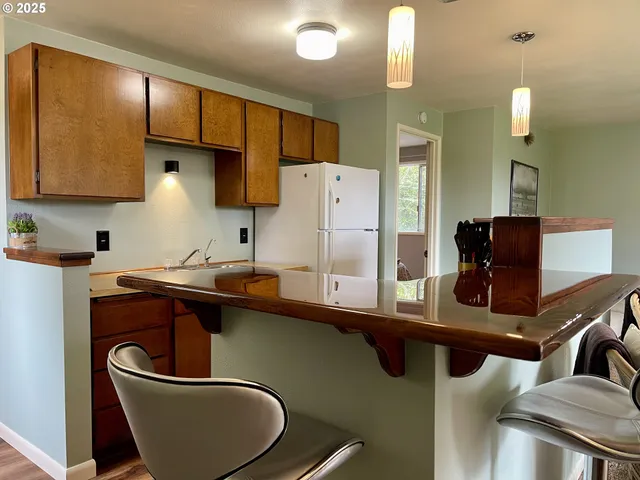a view of a hallway with wooden floor and a large window