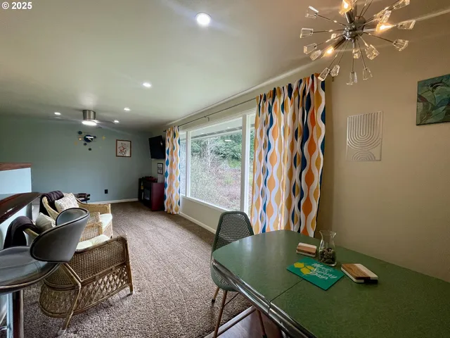a view of a hallway with couch and dining table