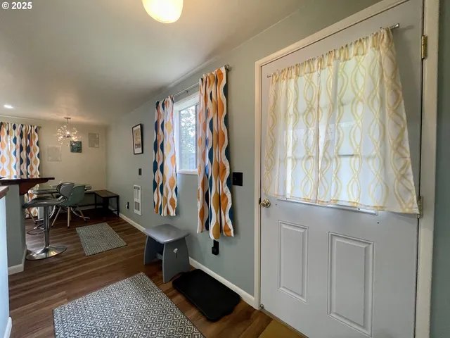 a kitchen with stainless steel appliances granite countertop a stove a sink dishwasher and a microwave with wooden floor