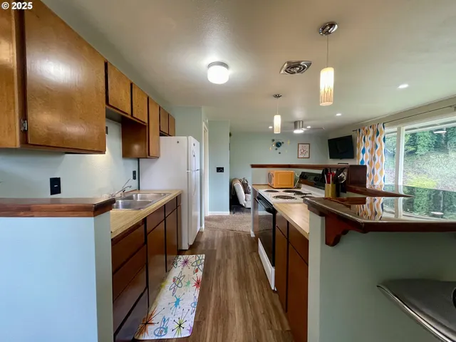 a living room with furniture and kitchen view
