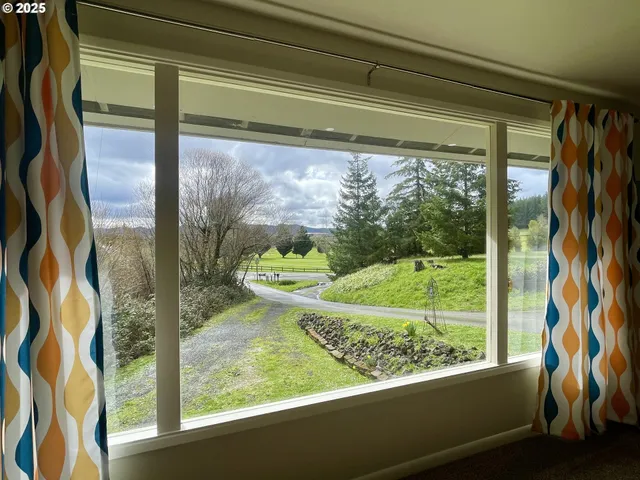 a view of backyard with barbeque grill and outdoor seating