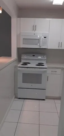 a white refrigerator freezer sitting in a kitchen