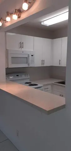 a kitchen with a refrigerator and a sink