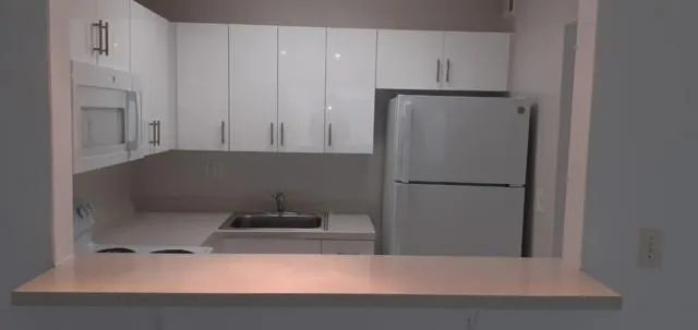 a view of a hallway and closet with a mirror