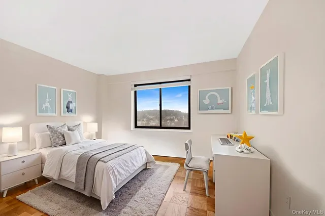 a bedroom with a bed and a painting on the wall