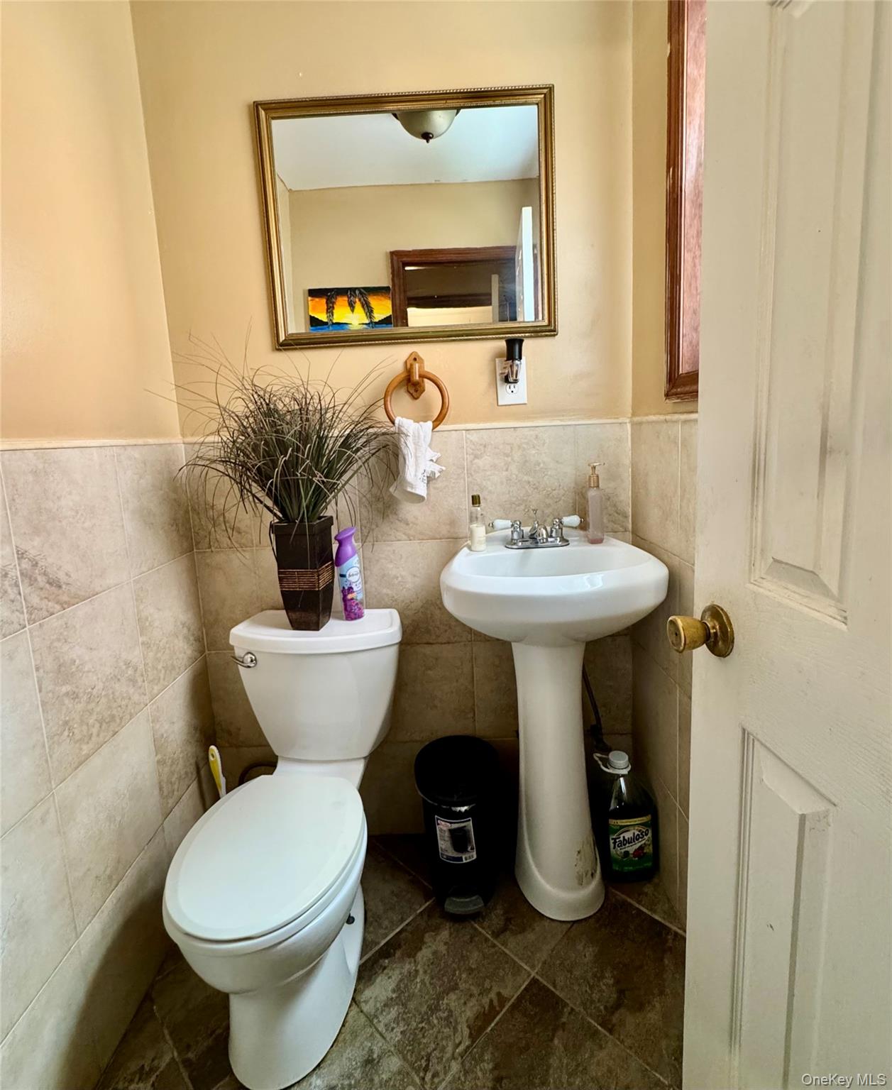 188-25 Mangin Avenue Queens, NY 11412 - Photo 3 of 10 Half bathroom with tile walls and a wainscoted wall