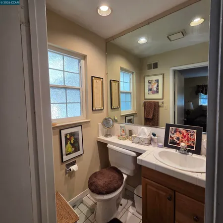 a bathroom with a sink toilet and a mirror