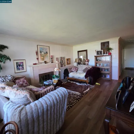 a living room with furniture large mirror and a fireplace