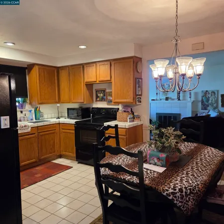 a kitchen with a table chairs and a stove